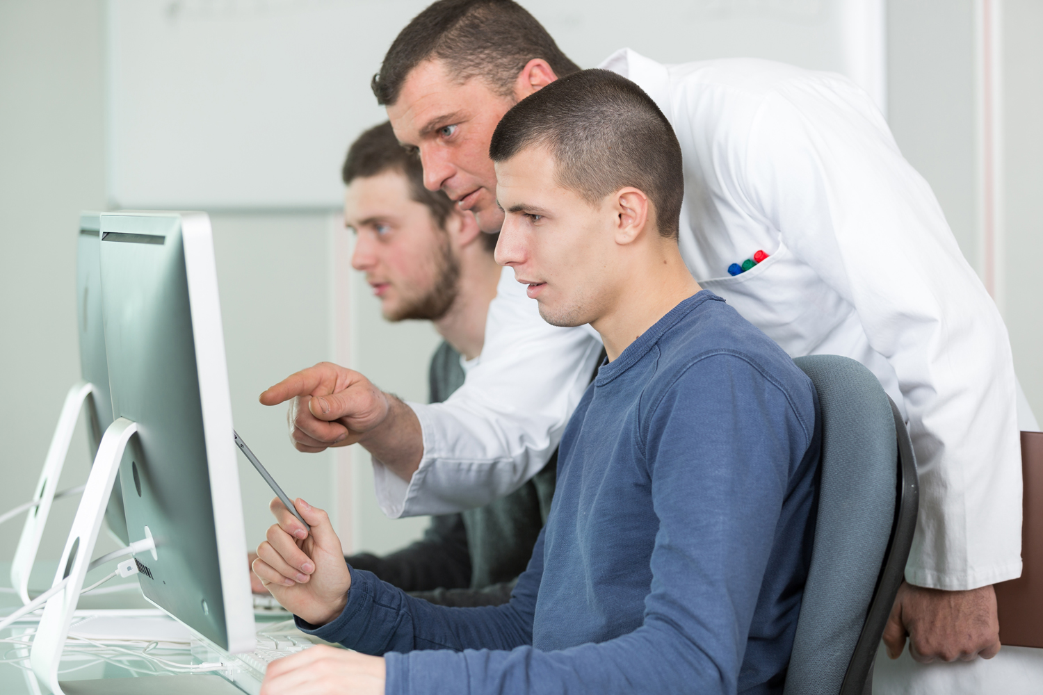 tutor and young students in computing class